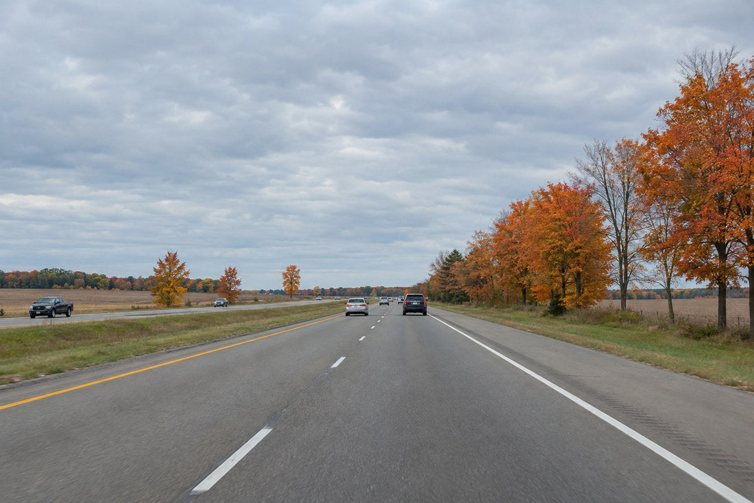 Michigan freeway through farmland with autumn maple trees - Michigan Left Lane Law