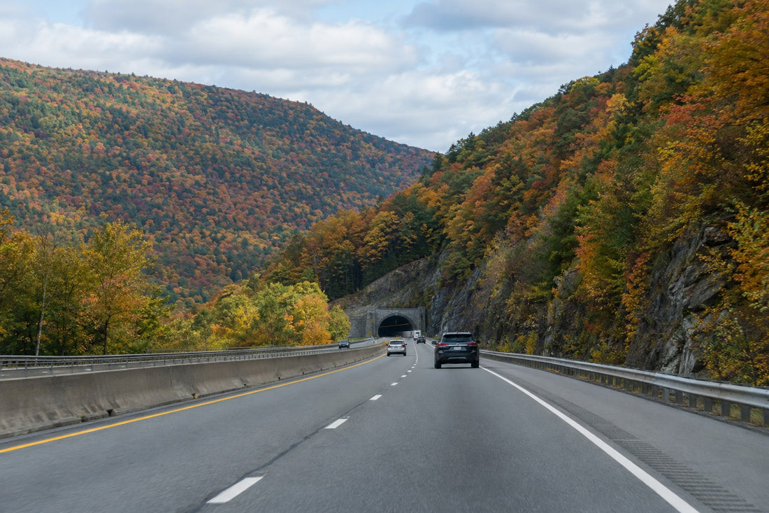 Pennsylvania highway through fall-foliage mountains toward a tunnel - Pennsylvania Left Lane Law